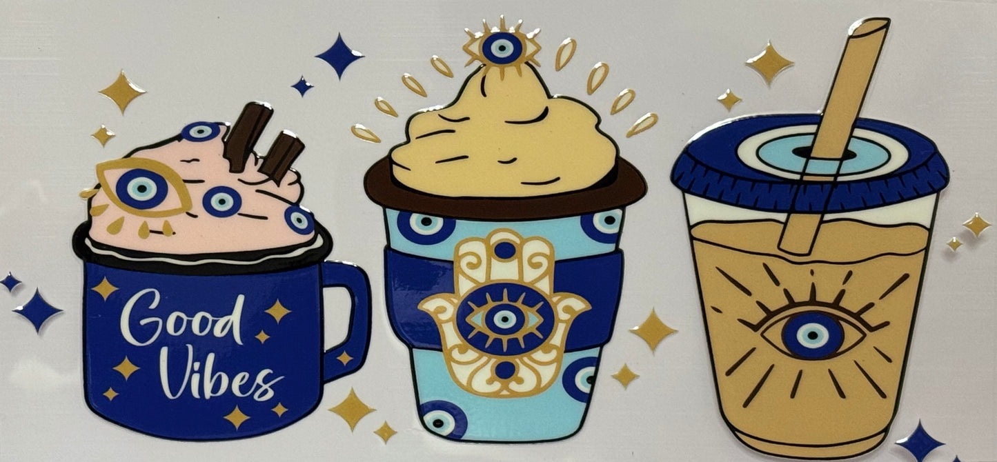 DTF wrap with three coffee cups decorated with evil eyes and hamsa designs