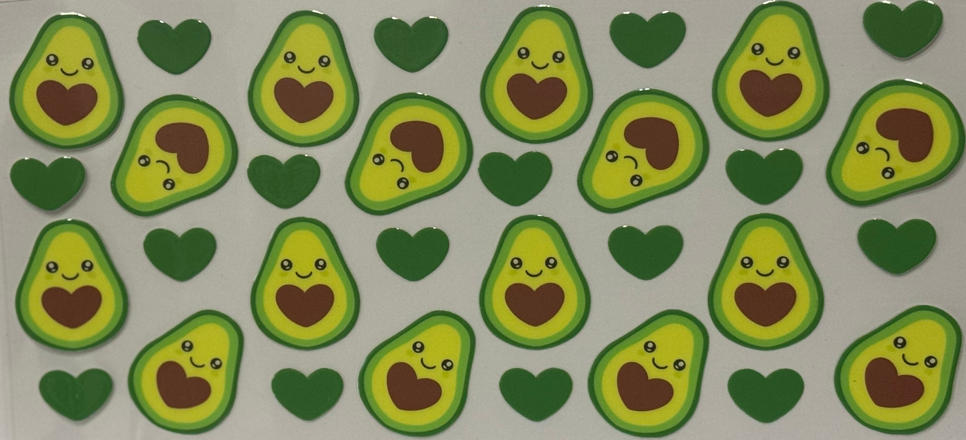  Cartoon avocados with brown heart centers and smiling faces mixed with green hearts.