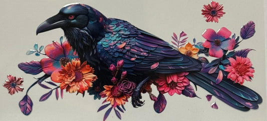 raven perched among vibrant pink and red flowers