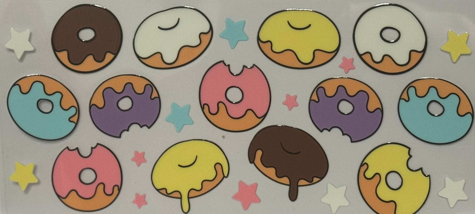 Various cartoon donuts with pastel icing, sprinkles, and small colorful stars.