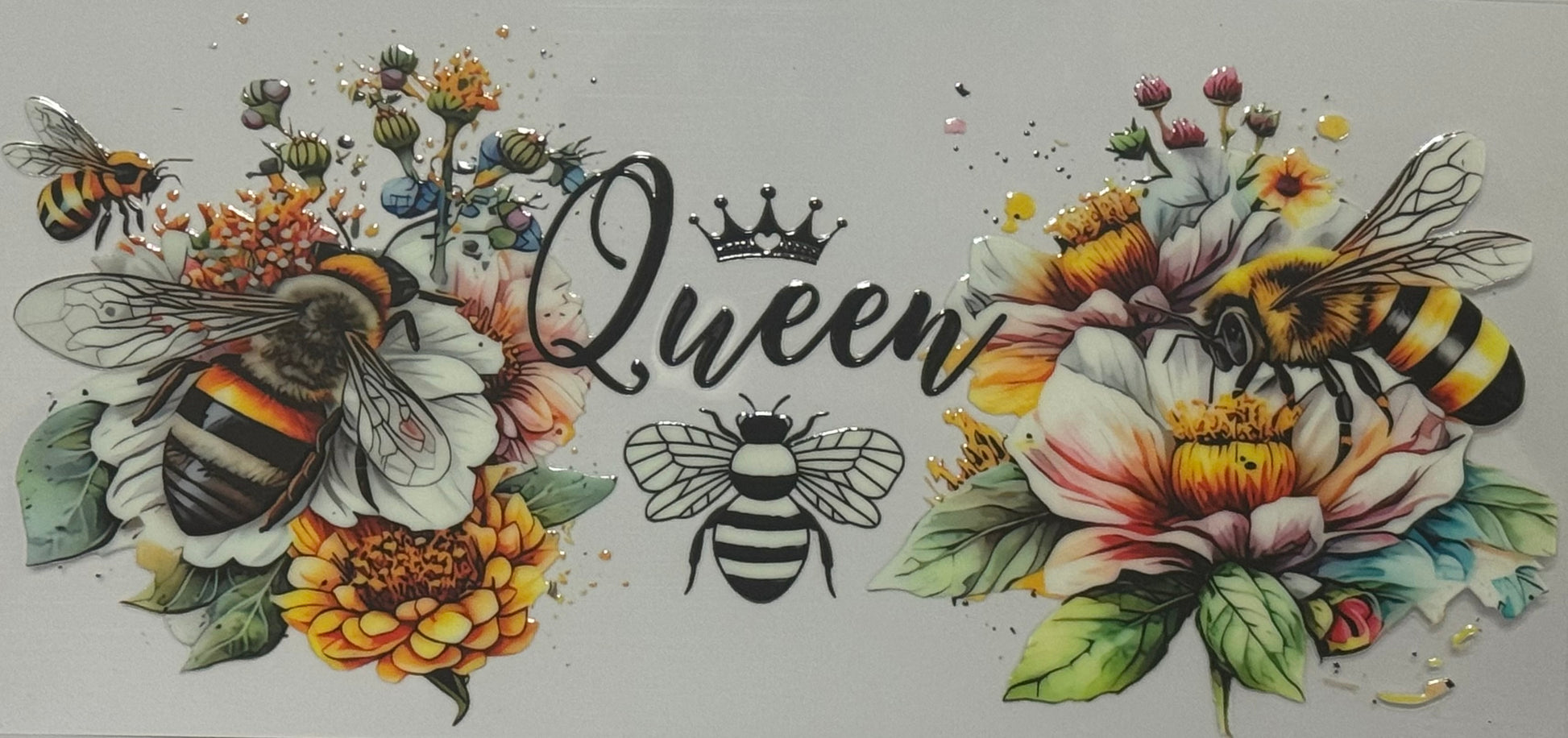 A wrap decorated with bees and colorful flowers surrounding the word “Queen” with a crown on top.