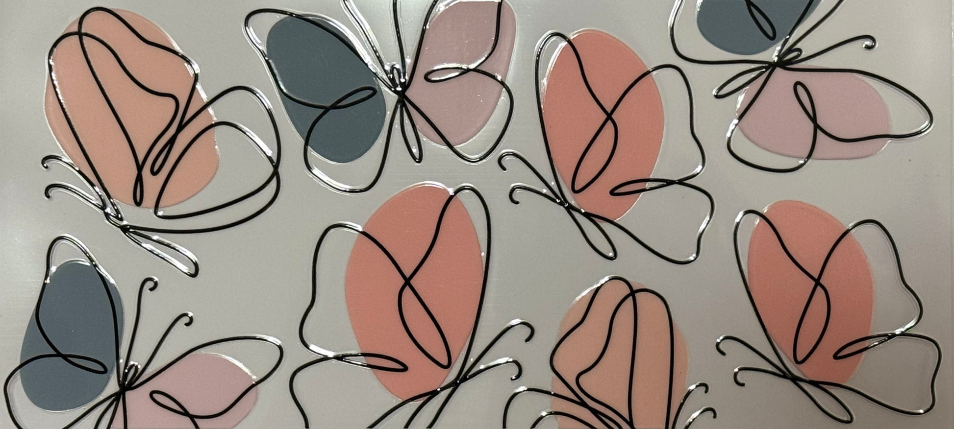 Abstract butterflies with black line outlines and filled with muted pink and grey shapes.