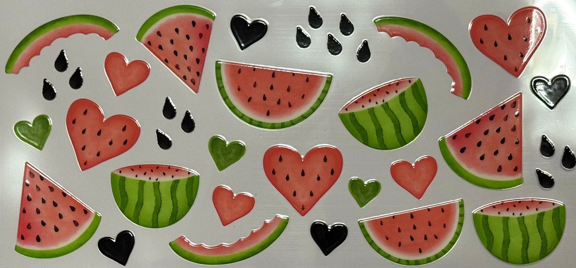 Watermelon slices, half melons, black seeds, and heart-shaped fruit pieces in red and green.