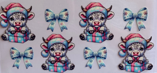 Christmas cow DTF wrap with Santa hats, presents, and pastel bows in pink and blue.